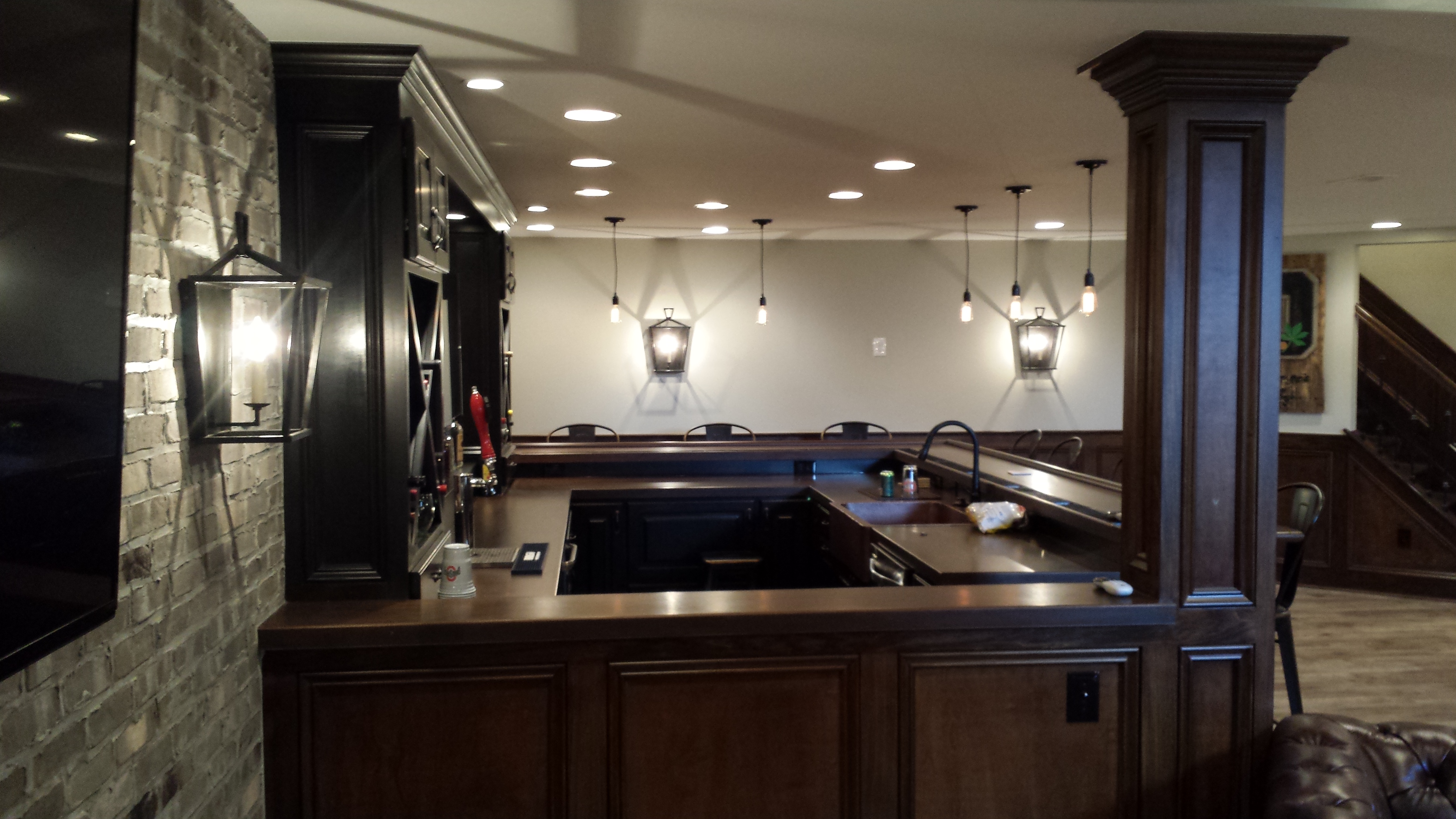 Finished Basement : Bar counter incorporated with wood pole and wainscoting
