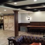 Bench seating area with unique barn door in basement remodel Bench seating area with unique barn door in basement remodel