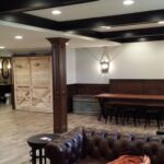 Bench seating area with unique barn door in basement remodel Bench seating area with unique barn door in basement remodel