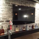 Custom brick finish in basement remodel with tv and bottle holder Custom brick finish in basement remodel with tv and bottle holder