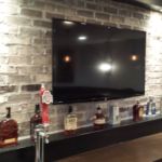 Custom brick finish in basement remodel with tv and bottle holder Custom brick finish in basement remodel with tv and bottle holder