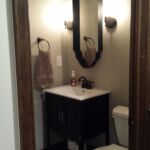 Basement finishing details: Half bath with deco tile and metal framed mirror in finished basement Basement finishing details: Half bath with deco tile and metal framed mirror in finished basement