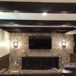 Basement area with custom beams, brick, sconces, and wainscoting Basement area with custom beams, brick, sconces, and wainscoting
